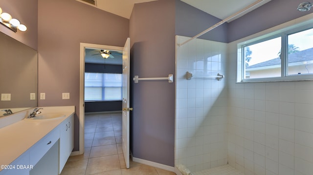 bathroom featuring ceiling fan, vanity, tile patterned flooring, and tiled shower