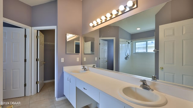 bathroom featuring vanity, tile patterned floors, and tiled shower