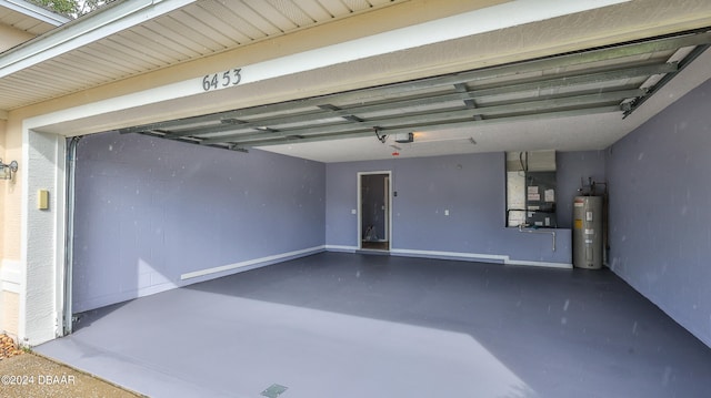 garage with a garage door opener, water heater, and heating unit