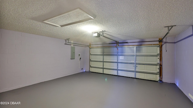 garage featuring electric panel and a garage door opener