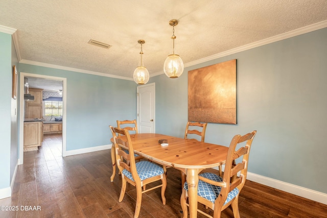 dining room featuring dark wood finished floors, baseboards, visible vents, and a textured ceiling
