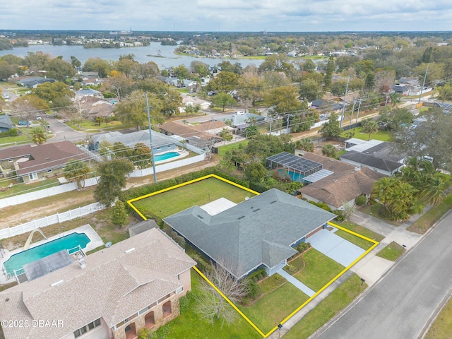 drone / aerial view featuring a water view and a residential view