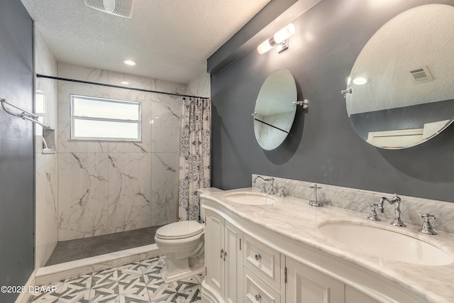 bathroom featuring visible vents, a sink, and a stall shower