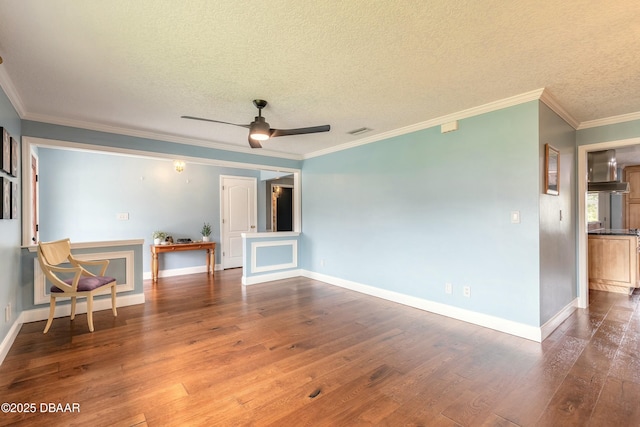 empty room featuring visible vents, wood finished floors, and baseboards