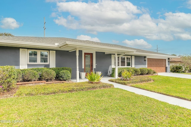 single story home with stucco siding, driveway, an attached garage, and a front yard