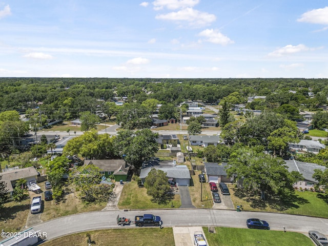 bird's eye view with a wooded view