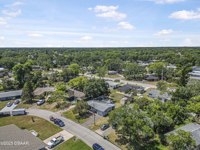 drone / aerial view with a residential view and a wooded view