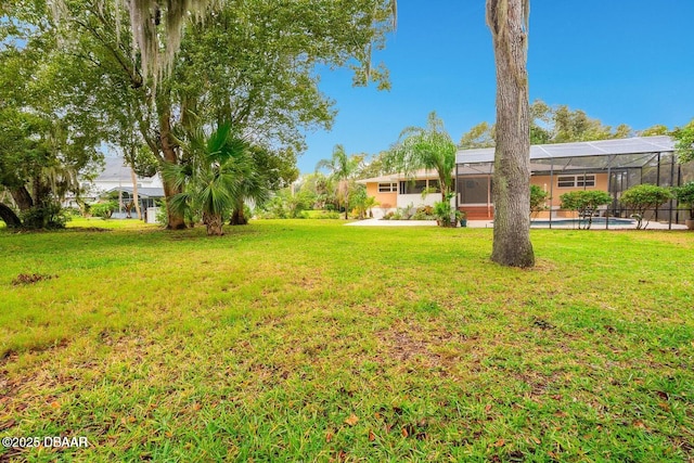 21 Pine Valley Cir, Ormond Beach, FL 32174 - view of green lawn with an outdoor pool and a lanai