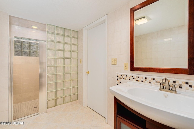 21 Pine Valley Cir, Ormond Beach, FL 32174 - bathroom featuring tile walls, a stall shower, vanity, and tile patterned floors