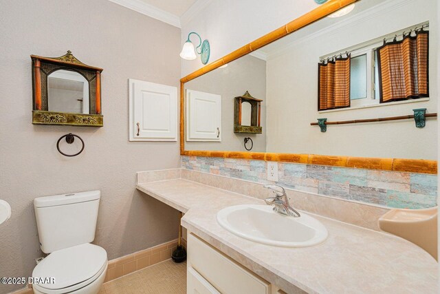 21 Pine Valley Cir, Ormond Beach, FL 32174 - bathroom featuring crown molding, vanity, tile patterned floors, and backsplash