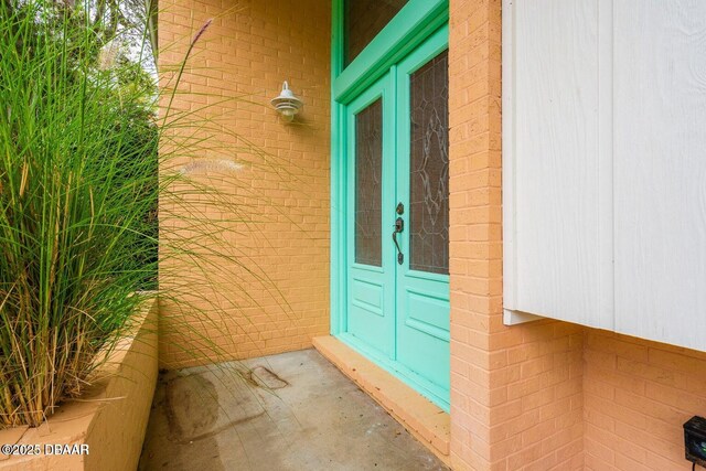21 Pine Valley Cir, Ormond Beach, FL 32174 - doorway to property featuring french doors and brick siding