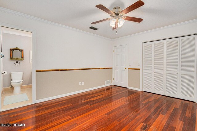 21 Pine Valley Cir, Ormond Beach, FL 32174 - unfurnished bedroom with wood finished floors, crown molding, ensuite bath, a ceiling fan, and a closet