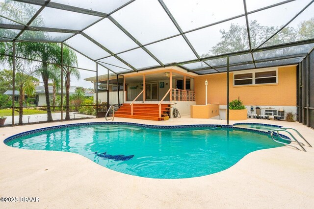 21 Pine Valley Cir, Ormond Beach, FL 32174 - swimming pool featuring a patio area, an in-ground hot tub, glass enclosure, and stairway