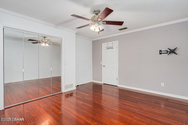 21 Pine Valley Cir, Ormond Beach, FL 32174 - unfurnished bedroom with wood finished floors, crown molding, a closet, and a ceiling fan