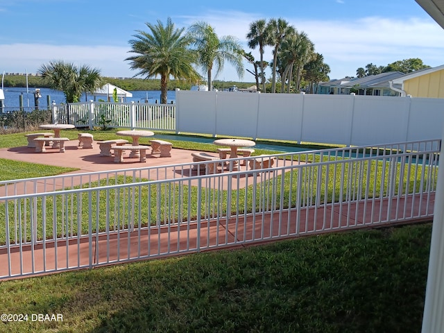 view of yard featuring a patio area and a water view