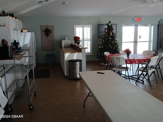 kitchen featuring white cabinetry and white fridge