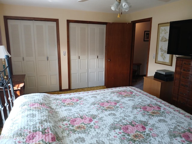 bedroom featuring ceiling fan and multiple closets