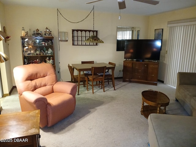 living room featuring ceiling fan and light carpet