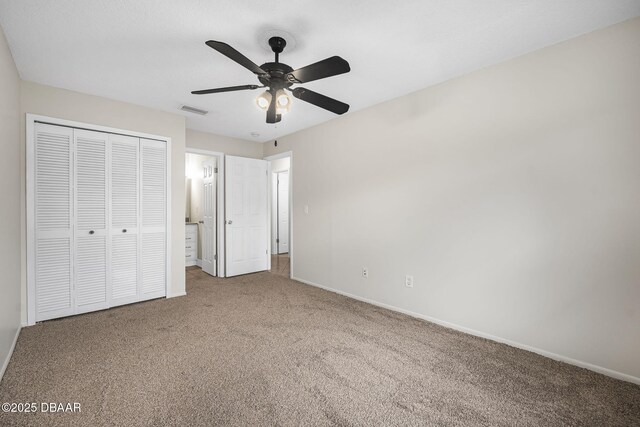 unfurnished bedroom featuring carpet, a closet, visible vents, ceiling fan, and baseboards