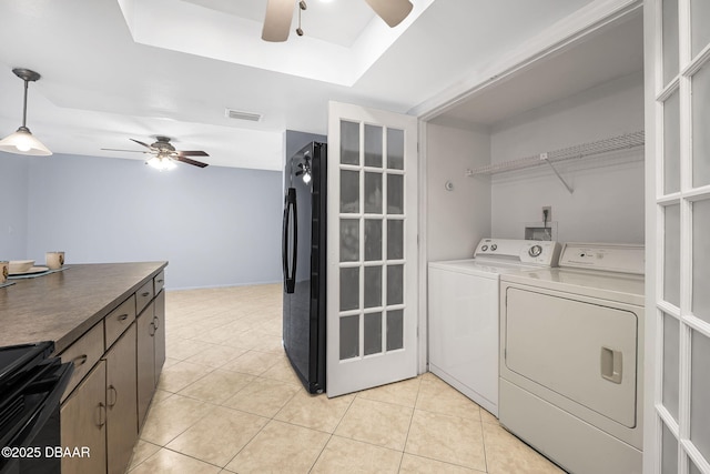 clothes washing area featuring laundry area, visible vents, ceiling fan, washer and dryer, and light tile patterned flooring