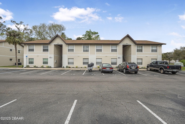 view of property featuring uncovered parking