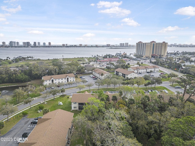 birds eye view of property featuring a water view and a city view