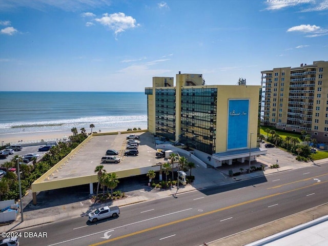 birds eye view of property with a water view and a beach view