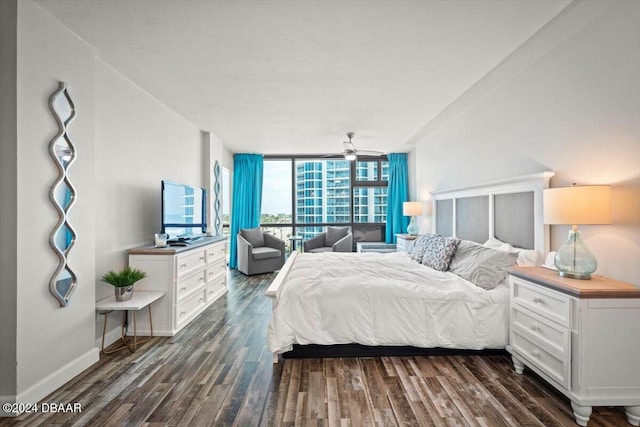 bedroom with expansive windows and dark wood-type flooring