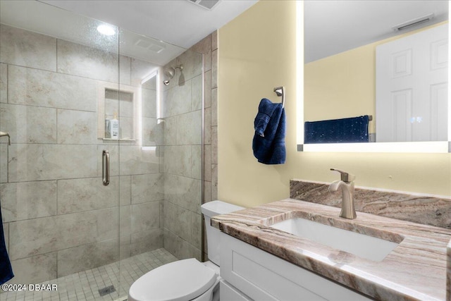 bathroom featuring vanity, toilet, and walk in shower