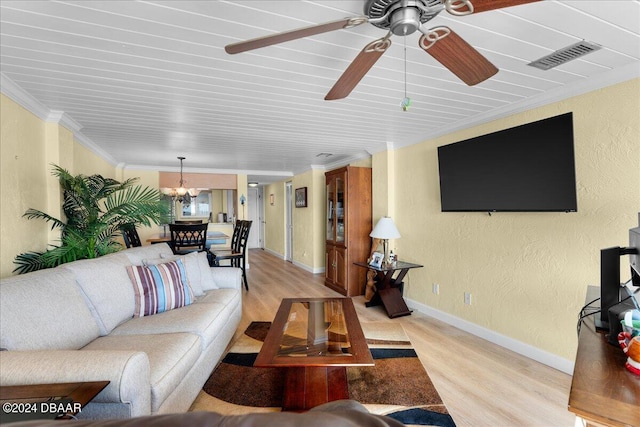 living room with ornamental molding, ceiling fan with notable chandelier, and light hardwood / wood-style flooring