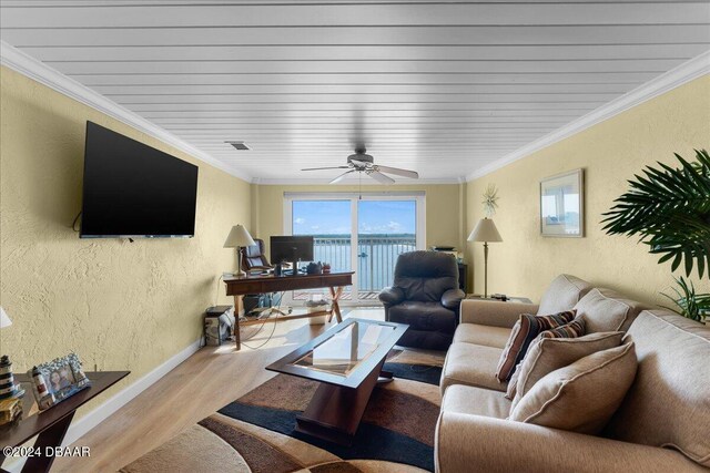 living room with ornamental molding, ceiling fan, and light hardwood / wood-style flooring