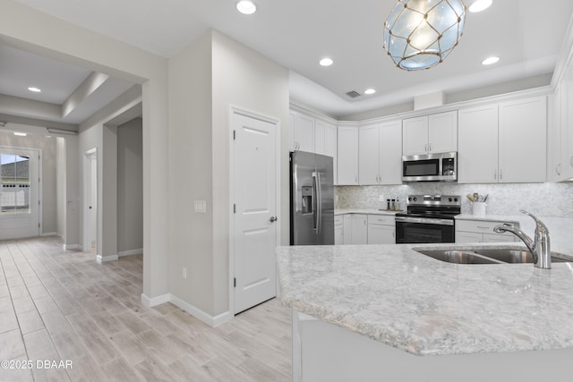 586 Lost Shaker Way, Daytona Beach, FL 32124 - kitchen with stainless steel appliances, a sink, baseboards, light stone counters, and white cabinets