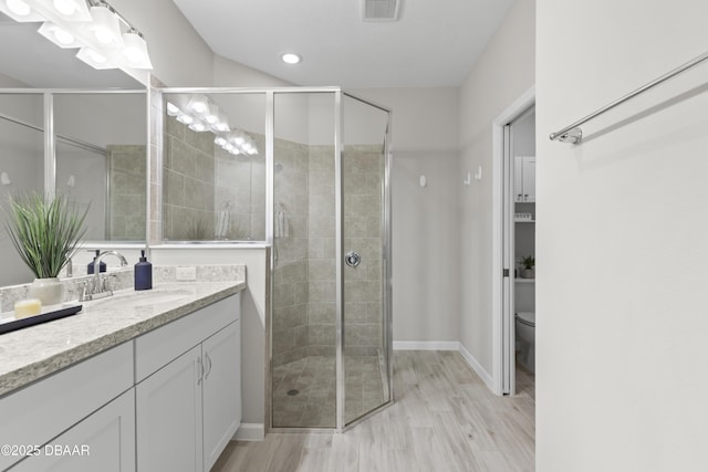 586 Lost Shaker Way, Daytona Beach, FL 32124 - full bathroom with vanity, a stall shower, toilet, wood finished floors, and baseboards