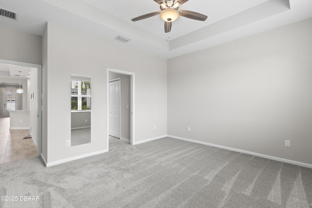 586 Lost Shaker Way, Daytona Beach, FL 32124 - unfurnished bedroom with carpet, a tray ceiling, and baseboards