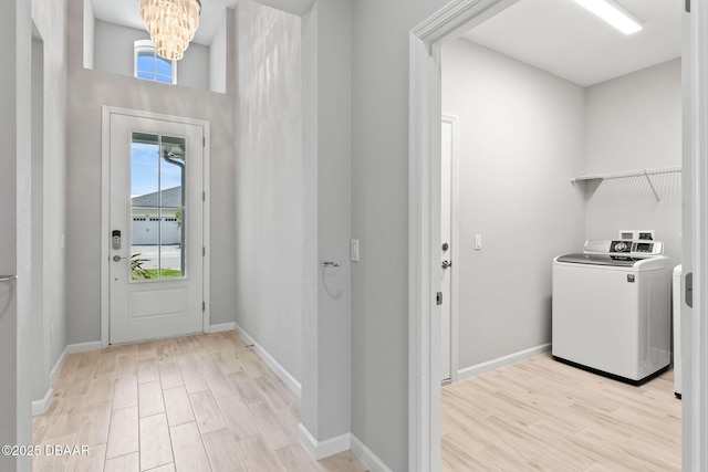 586 Lost Shaker Way, Daytona Beach, FL 32124 - washroom featuring washer / clothes dryer, light wood finished floors, healthy amount of natural light, and a chandelier