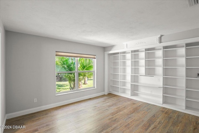 spare room with hardwood / wood-style flooring and a textured ceiling