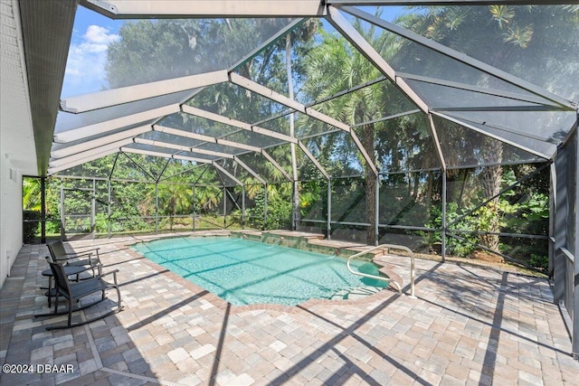 view of pool with a lanai and a patio area