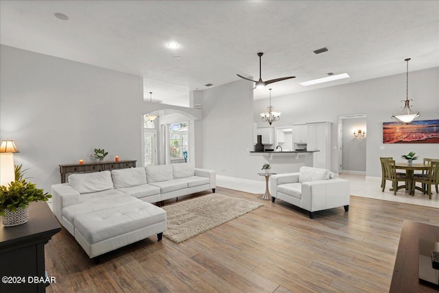 living room with ceiling fan and light hardwood / wood-style flooring