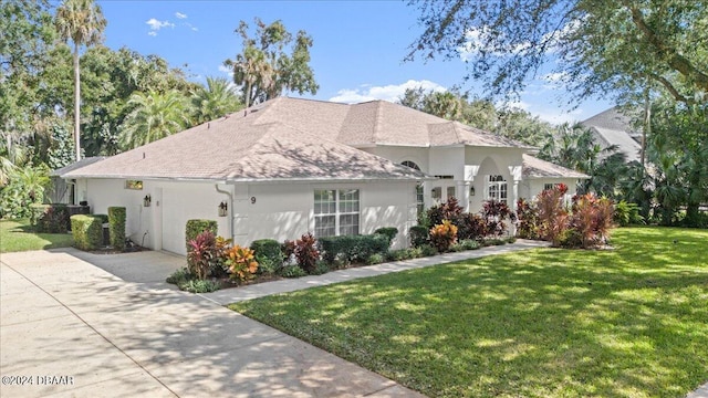 mediterranean / spanish house featuring a front yard