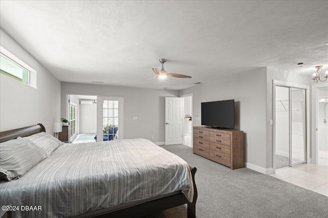 bedroom featuring a closet, multiple windows, light carpet, and ceiling fan with notable chandelier