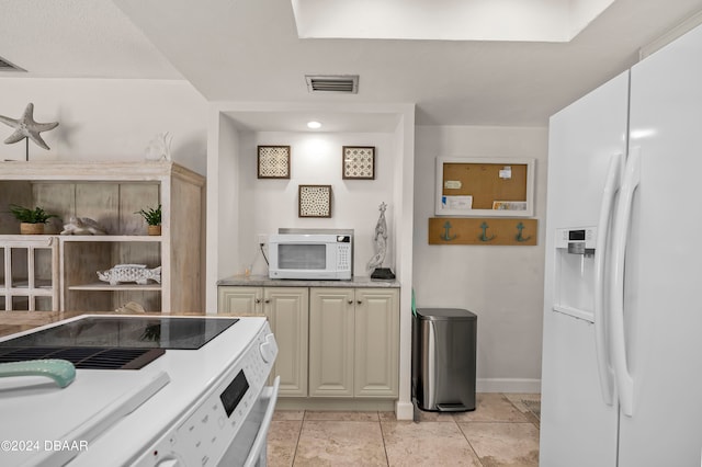 kitchen with light tile patterned floors and white appliances