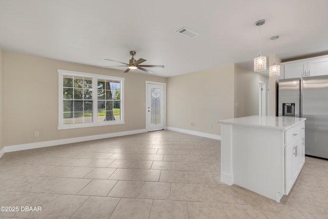 kitchen with stainless steel refrigerator with ice dispenser, light countertops, visible vents, white cabinets, and a kitchen island