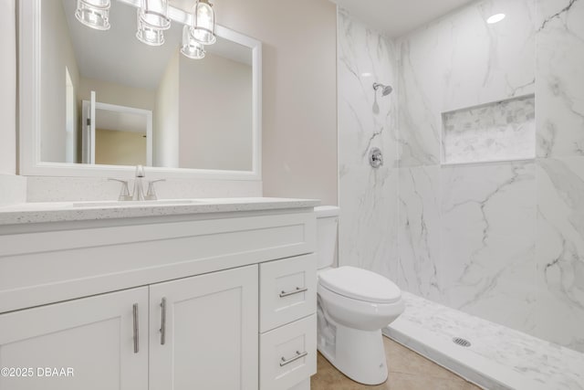 bathroom featuring toilet, vanity, and a marble finish shower