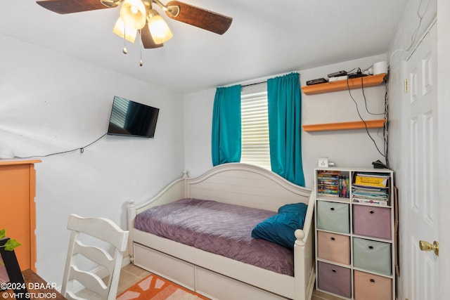 bedroom with light tile patterned floors and ceiling fan