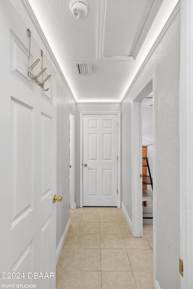 39 Brooks Dr, Ormond Beach, FL 32176 - hall featuring light tile patterned floors, a textured ceiling, and baseboards