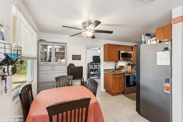 kitchen with ceiling fan, light tile patterned floors, and appliances with stainless steel finishes