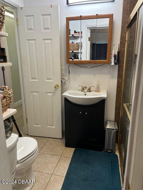 bathroom with vanity, tile patterned floors, and toilet