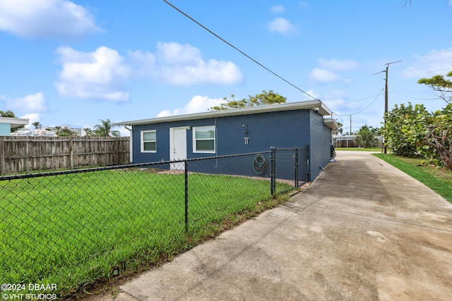 view of side of home with a lawn