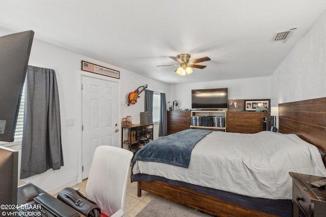 tiled bedroom featuring ceiling fan