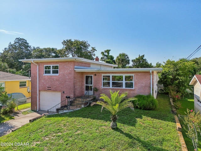 view of front of property with a garage and a front yard